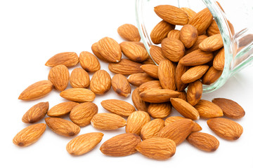 Almonds spilling from a glass container