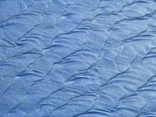 Abstract background of blue sand ripples at the beach