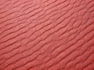 Abstract background of red sand ripples at the beach