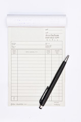 Cash Sale Book with a black pen on white background