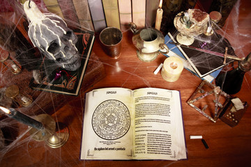 top view of table full of witchcraft related objects and cobwebs