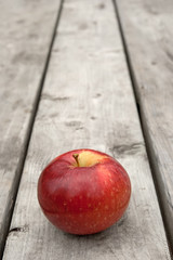 Ripe red apple on old wooden table