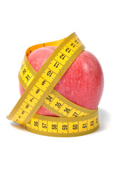 Red apple and measure tape over white