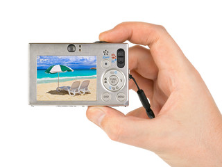 Hand with camera and beach landscape (my photo)