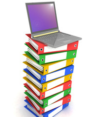 Colorful books next to a modern laptop