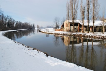 Country house on the river in winter, Po valley, Italy