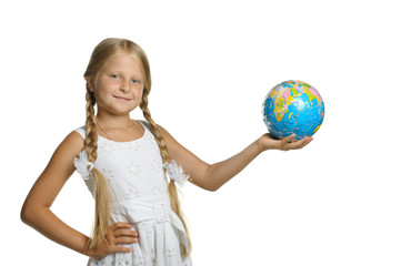 Fototapeta premium The girl holds the globe collected from puzzle in hands. Selecti
