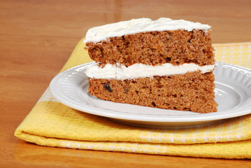 carrot cake on a plate with yellow napkin