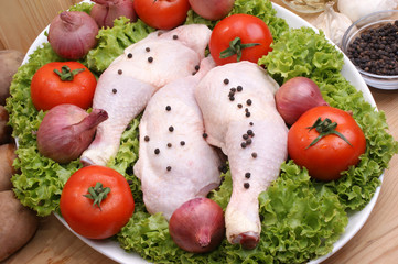 rohe Hühncherschenkel mit Tomaten und Zwiebeln