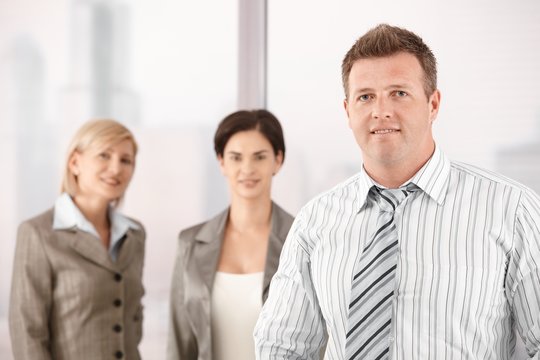 Businessman with female coworkers