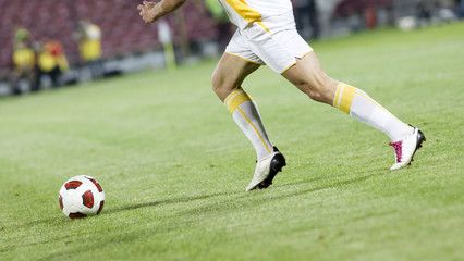 Soccer player running after the ball