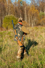 Hunter walking over meadow and searching for moose