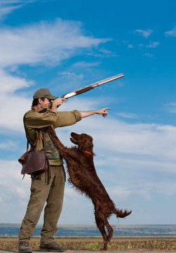 Hunter Training The Hunting Dog During Hunt