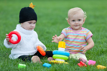 Two little girls are playing outdoor