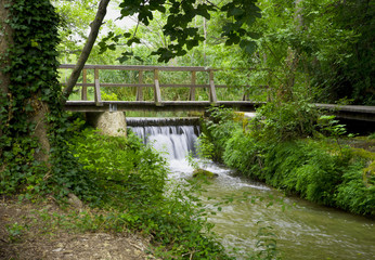 Fototapeta na wymiar wooden bridge over a small waterfall