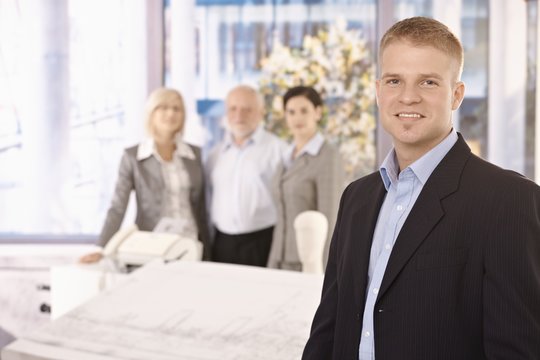 Young businessman in office with team