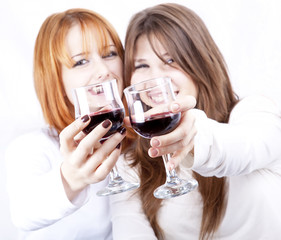 Two girlfriends with two glasses of wine.
