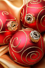 Three red christmas baubles