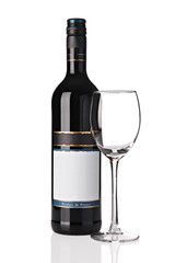 Bottle of red wine with empty glass