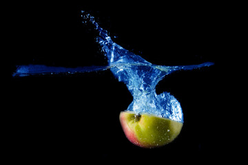 Apple splashing on black background