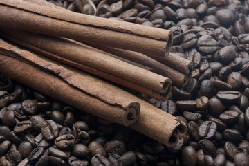 cinnamon sticks on heap of coffee beans
