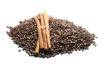 cinnamon sticks on heap of coffee beans