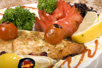 Fried filleted fish with lemon and vegetables