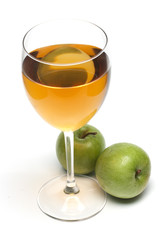 glass of juice and two apples