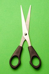 Scissors isolated on green