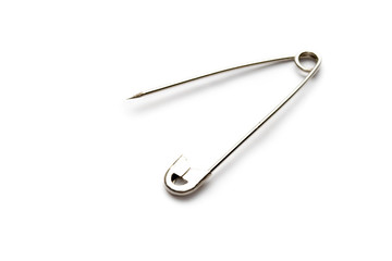Safety pin isolated on the white background