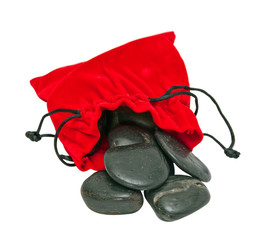 Decorative stones in a red pouch isolated on white background.