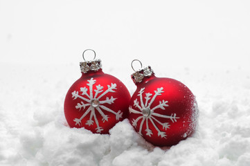 Red Christmas balls in snow