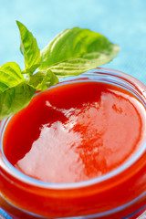 Tomato sauce with basil leaves