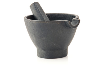 Cast-iron mortar with pestle over white