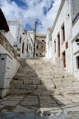 Fototapeta na wymiar The uphill street steps in Aperanthos, Naxos, Greece