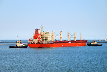 Tug boat helps to maneuver the ship