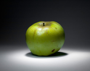 Green apple in the dark room