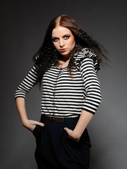 Beautiful fashion woman in stripy top with creative make-up posi