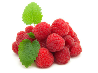 Raspberries with green leaves on white background