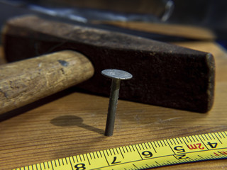 Nail, hammer and measuring tape