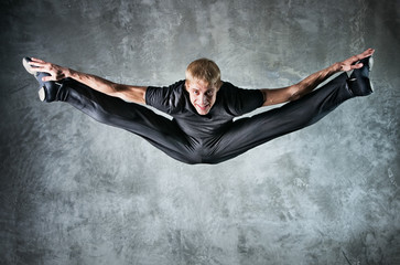 Young man dancer jumping up high