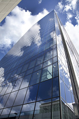 Fototapeta na wymiar High modern skyscraper on a background of the blue sky
