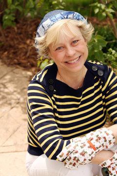 mature woman with gardening gloves