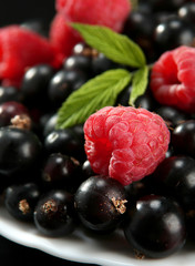 Raspberry with leaf on black currant detail