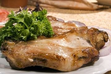 Fried juicy meat served with salad