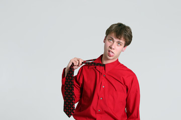 teen boy pulling on necktie