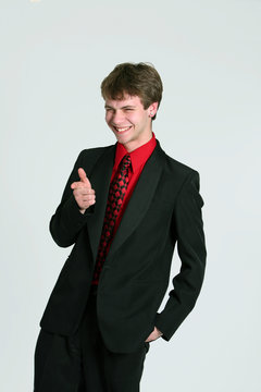 teen boy in suit pointing