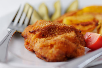 Delicious schnitzel with baked potatoes