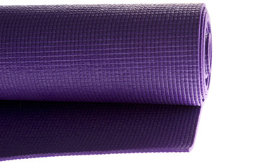 rolled yoga mat on white
