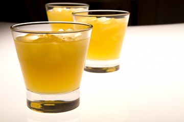glass of orange juice with ice